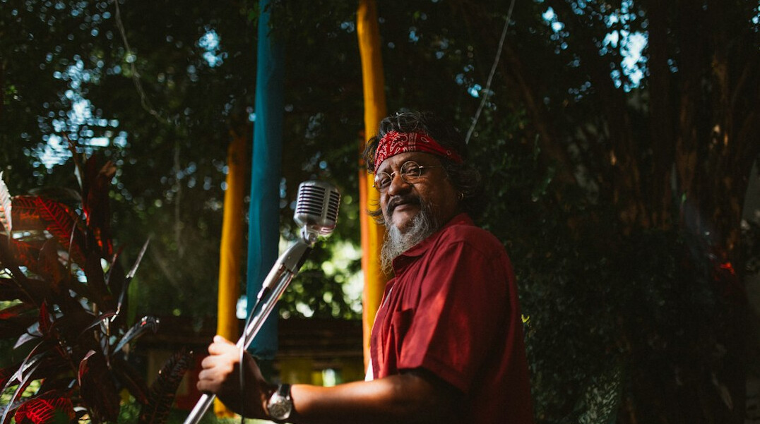 Boom operator holding a microphone boom pole on set