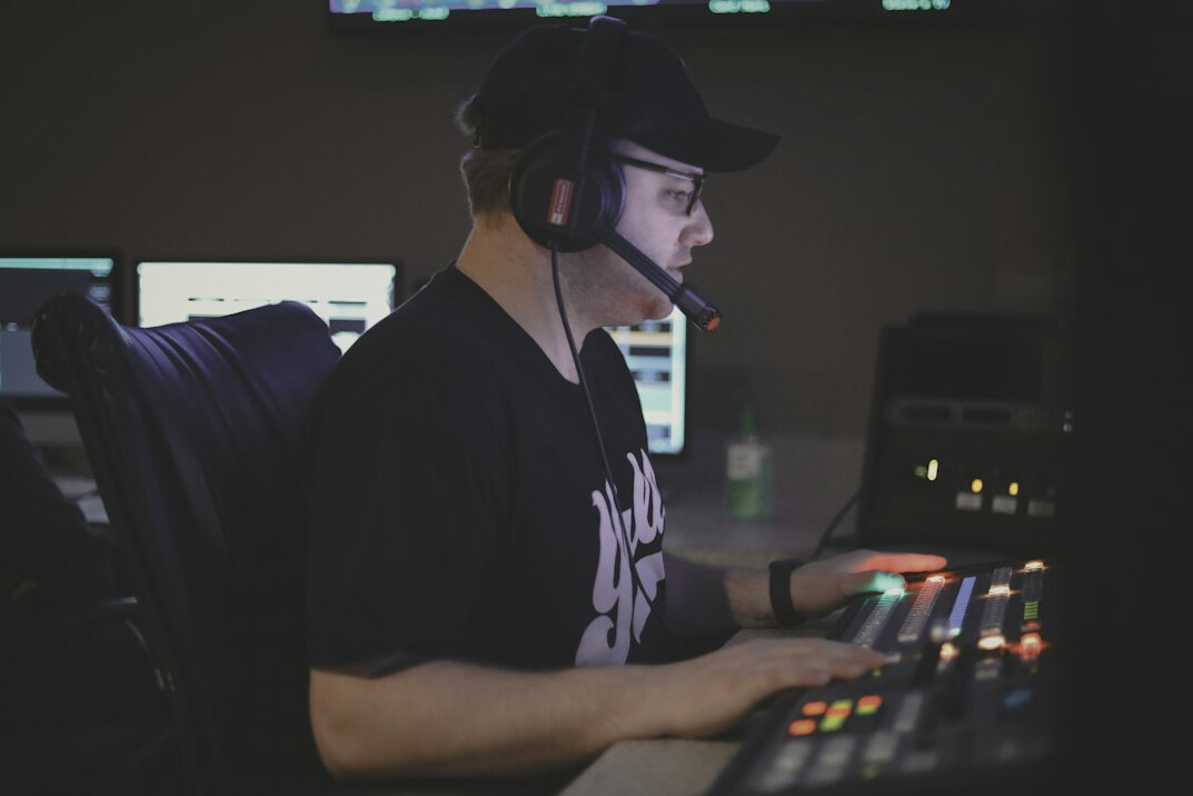 Broadcast control room with multiple monitors and camera feeds